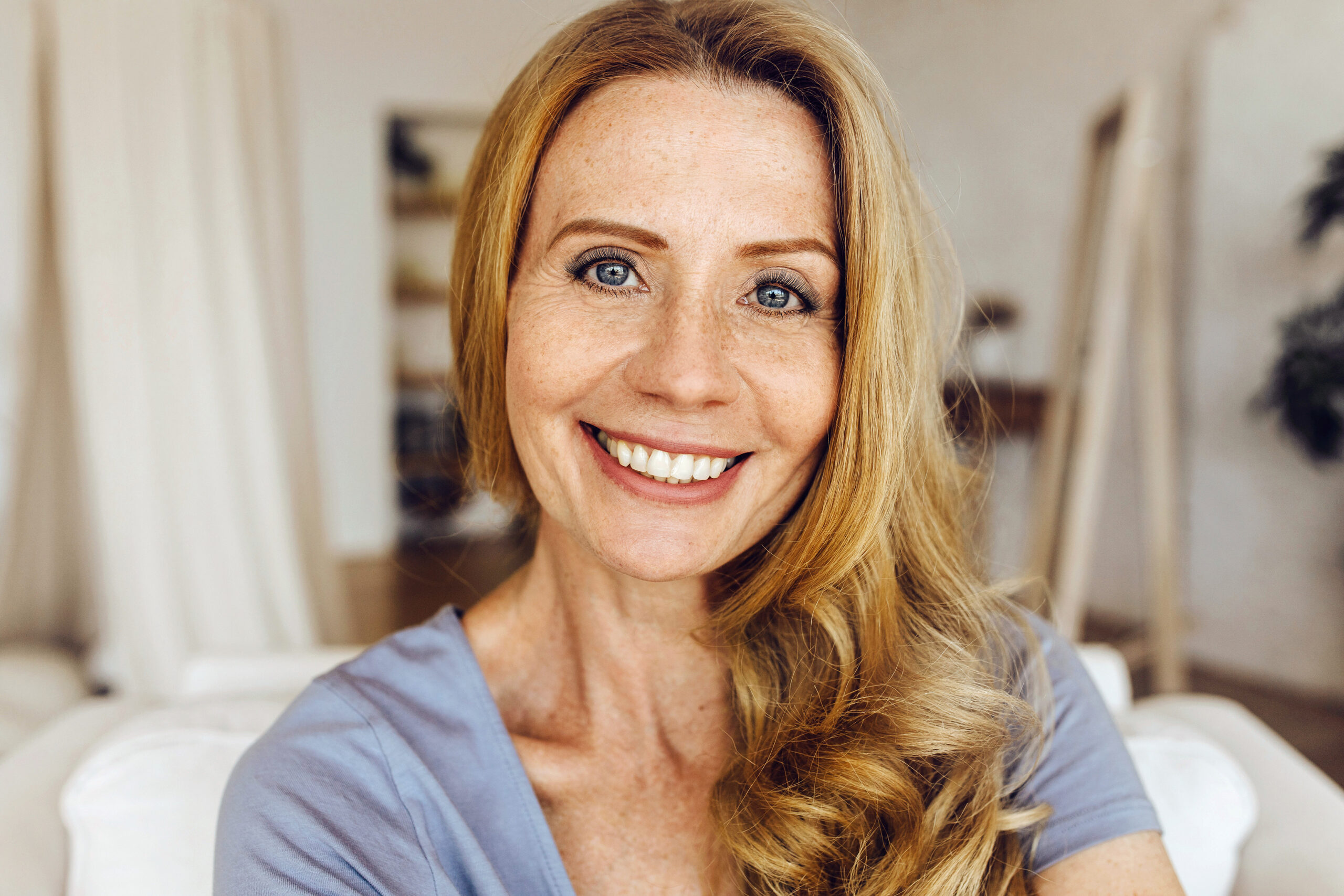 mid-shot of smiling woman with tinted brows