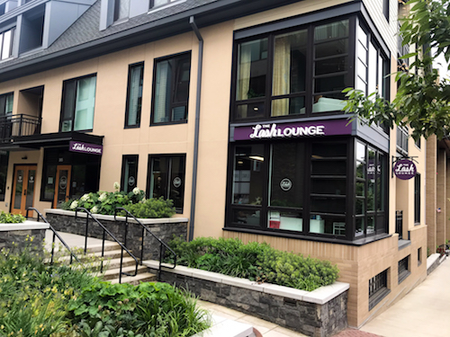 Exterior shot of The Lash Lounge salon with lush green landscape